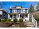 Charming two-story home with a red door, inviting front porch, and well-manicured landscaping at 4350 N College Ave, Indianapolis, IN 46205