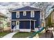 Charming two-story home with a blue exterior, well-manicured lawn, and a welcoming walkway leading to the front door at 4350 N College Ave, Indianapolis, IN 46205