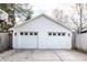 Detached two-car garage with white siding and classic carriage-style doors, offering ample parking and storage space at 4350 N College Ave, Indianapolis, IN 46205