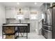 Bright kitchen features white cabinetry, subway tile, and modern stainless steel appliances at 4350 N College Ave, Indianapolis, IN 46205