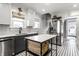 Bright kitchen features sleek, stainless-steel appliances and a kitchen island with woven basket storage at 4350 N College Ave, Indianapolis, IN 46205
