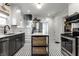 An open kitchen with stainless steel appliances and stylish black and white patterned tile flooring at 4350 N College Ave, Indianapolis, IN 46205