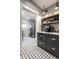 Stylish kitchen features dark gray cabinets, open wood shelving, and modern appliances at 4350 N College Ave, Indianapolis, IN 46205