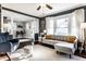 Sunlit living room with modern gray sofa, soft rug, and stylish decor at 4350 N College Ave, Indianapolis, IN 46205
