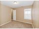 Bedroom showing neutral colors, carpet, window and an open closet at 5010 Elliott Ave, Indianapolis, IN 46201
