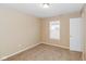 Simple bedroom with neutral walls, carpet, and natural light at 5010 Elliott Ave, Indianapolis, IN 46201