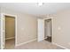 Bedroom featuring neutral walls, carpet and white doors for a calm and peaceful ambiance at 5010 Elliott Ave, Indianapolis, IN 46201