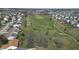 Scenic aerial view of a golf course community with a pond and well-maintained green spaces at 5233 Birmingham Dr, Indianapolis, IN 46235