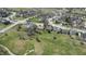 Aerial view of a home in a golf course community, featuring mature trees and green spaces at 5233 Birmingham Dr, Indianapolis, IN 46235