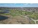 Scenic aerial view of a golf course community with a pond and well-maintained green spaces at 5233 Birmingham Dr, Indianapolis, IN 46235