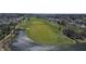 Scenic aerial view of a golf course community with a pond and well-maintained green spaces at 5233 Birmingham Dr, Indianapolis, IN 46235