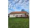 A well-maintained backyard with a wood deck and a view of the home's exterior at 5233 Birmingham Dr, Indianapolis, IN 46235