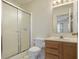 Bathroom features include a glass shower door, tile flooring, and a wood vanity at 5233 Birmingham Dr, Indianapolis, IN 46235