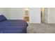 Bedroom featuring gray carpeting and view to the ensuite bathroom and closet at 5233 Birmingham Dr, Indianapolis, IN 46235