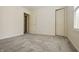 Bedroom with neutral carpet, window, and white doors at 5233 Birmingham Dr, Indianapolis, IN 46235