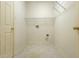 Empty walk-in closet featuring vinyl flooring, shelving, and a door at 5233 Birmingham Dr, Indianapolis, IN 46235