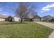Charming brick home featuring an attached two-car garage and a well-manicured lawn at 5233 Birmingham Dr, Indianapolis, IN 46235