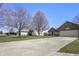 Charming brick home featuring an attached two-car garage and a well-manicured lawn at 5233 Birmingham Dr, Indianapolis, IN 46235