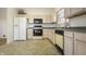 Well-lit kitchen featuring essential appliances and lots of cabinet storage at 5233 Birmingham Dr, Indianapolis, IN 46235