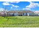 Exterior view of the home showcasing a spacious backyard and a deck area for outdoor enjoyment at 5737 Misty Ridge Cir, Indianapolis, IN 46237
