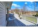 Relax on this spacious backyard deck, complete with white fencing, a table and a scenic neighborhood view at 5737 Misty Ridge Cir, Indianapolis, IN 46237