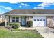 Charming single-story brick home featuring an attached garage and manicured landscaping at 5737 Misty Ridge Cir, Indianapolis, IN 46237
