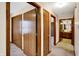Hallway featuring multiple closet doors, leading to the bathroom at 5737 Misty Ridge Cir, Indianapolis, IN 46237