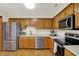 Well-lit kitchen featuring stainless steel appliances and wooden cabinets at 5737 Misty Ridge Cir, Indianapolis, IN 46237