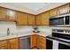 Bright kitchen showcasing stainless steel appliances, wood cabinets, and sleek countertops at 5737 Misty Ridge Cir, Indianapolis, IN 46237