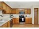 Functional kitchen with wooden cabinetry, modern appliances, and ample counter space at 5737 Misty Ridge Cir, Indianapolis, IN 46237