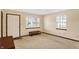 Bright living room showcasing new carpeting, large windows, and a decorative wooden bench at 5737 Misty Ridge Cir, Indianapolis, IN 46237
