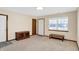 Spacious living room featuring neutral carpeting, large windows, and a beautiful entryway at 5737 Misty Ridge Cir, Indianapolis, IN 46237
