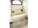 A relaxing soaking tub featuring stylish fixtures and bright natural lighting under an arched window at 5949 Willow Bend Dr, Avon, IN 46123