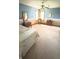 A bright bedroom featuring soft carpet, a patterned armchair, and charming wall art under a ceiling fan at 5949 Willow Bend Dr, Avon, IN 46123