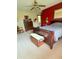 This bedroom boasts a red accent wall, wood dresser, and plush carpeting at 5949 Willow Bend Dr, Avon, IN 46123