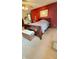 Spacious bedroom with a red accent wall, sleigh bed, and neutral carpeting at 5949 Willow Bend Dr, Avon, IN 46123