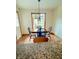 Cozy dining area with wood floors, traditional chandelier, and views of the living room at 5949 Willow Bend Dr, Avon, IN 46123
