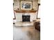 Close up of the living rooms painted brick fireplace with wood mantle at 5949 Willow Bend Dr, Avon, IN 46123