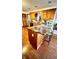 Well-designed kitchen with a center island, granite countertops, wooden cabinets and floors, and an eat-in bar at 5949 Willow Bend Dr, Avon, IN 46123