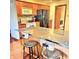 Eat-in kitchen island with bar stool seating, granite countertop, and wood cabinets at 5949 Willow Bend Dr, Avon, IN 46123