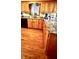 Spacious kitchen features wood cabinets, granite counters, wood flooring, and stainless appliances at 5949 Willow Bend Dr, Avon, IN 46123