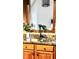 Close up of the kitchen sink, granite countertops, and backsplash with a wooden trimmed mirror at 5949 Willow Bend Dr, Avon, IN 46123
