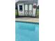 Poolside view of a charming backyard shed with painted details at 5949 Willow Bend Dr, Avon, IN 46123