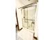 Enclosed shower with glass doors, bench, and chrome fixtures, creating a practical and modern bathroom space at 5949 Willow Bend Dr, Avon, IN 46123