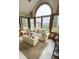 Light-filled sunroom featuring a large arched window with views of the backyard at 5949 Willow Bend Dr, Avon, IN 46123
