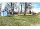 Expansive backyard with mature trees, well-maintained lawn, and a driveway leading to the house at 5967 Oak Hill East Dr, Plainfield, IN 46168