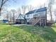 Large backyard with a deck and stairs attached to the rear of this two story home at 5967 Oak Hill East Dr, Plainfield, IN 46168