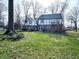 Two-story home with a large backyard, mature trees, a patio, and deck at 5967 Oak Hill East Dr, Plainfield, IN 46168