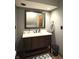 Bathroom vanity with neutral countertops, dark cabinets, and an oversized mirror at 5967 Oak Hill East Dr, Plainfield, IN 46168
