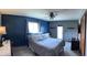 Bedroom features a queen-sized bed, ceiling fan, and a walk out door at 5967 Oak Hill East Dr, Plainfield, IN 46168